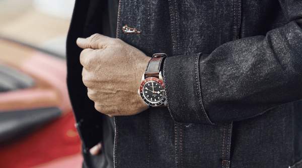 An elegant individual in a luxurious setting, contemplating the exclusivity and psychological allure of high-end brands.